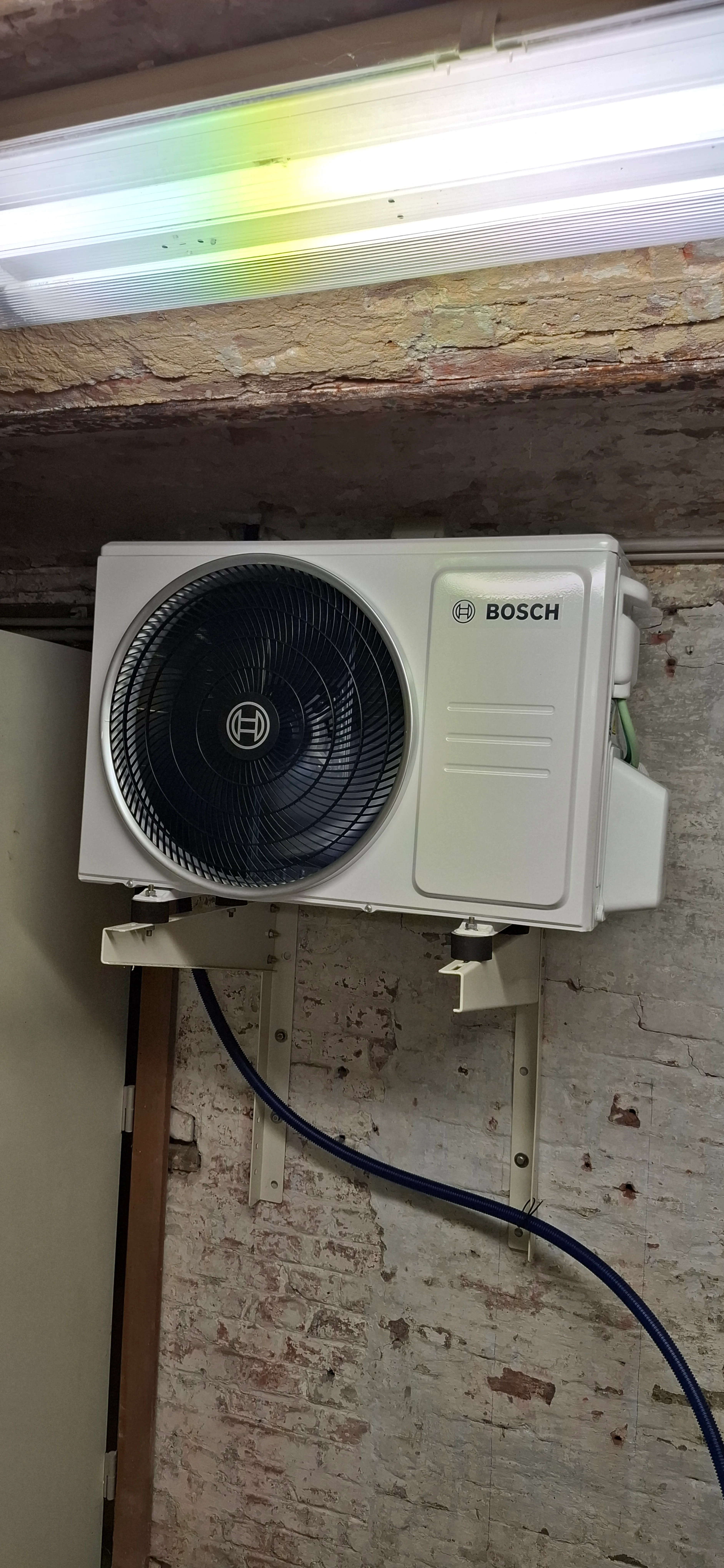 Airco unit geïnstalleerd aan de muur in een technische ruimte